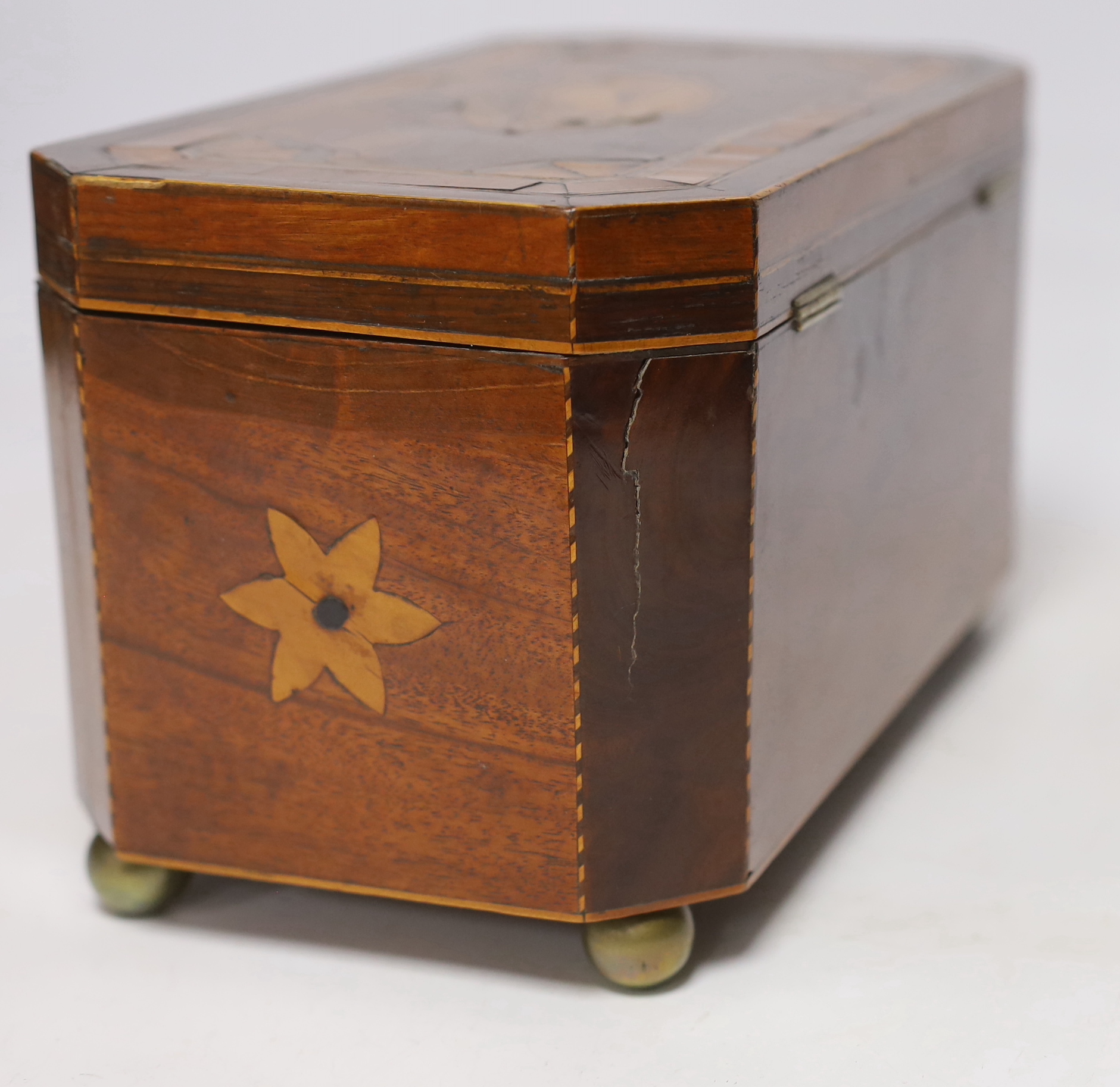 An early 19th century shell inlaid cross banded mahogany tea caddy, 26cm wide
